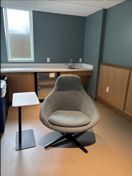 photo of room: include chair, sink, outlets, counter top, small table