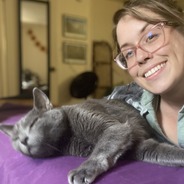 picture of jessica scott smiling with their gray cat in the foreground